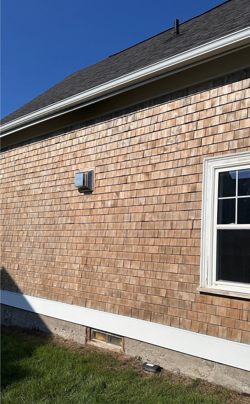 Restored golden cedar shake siding after wood brightening