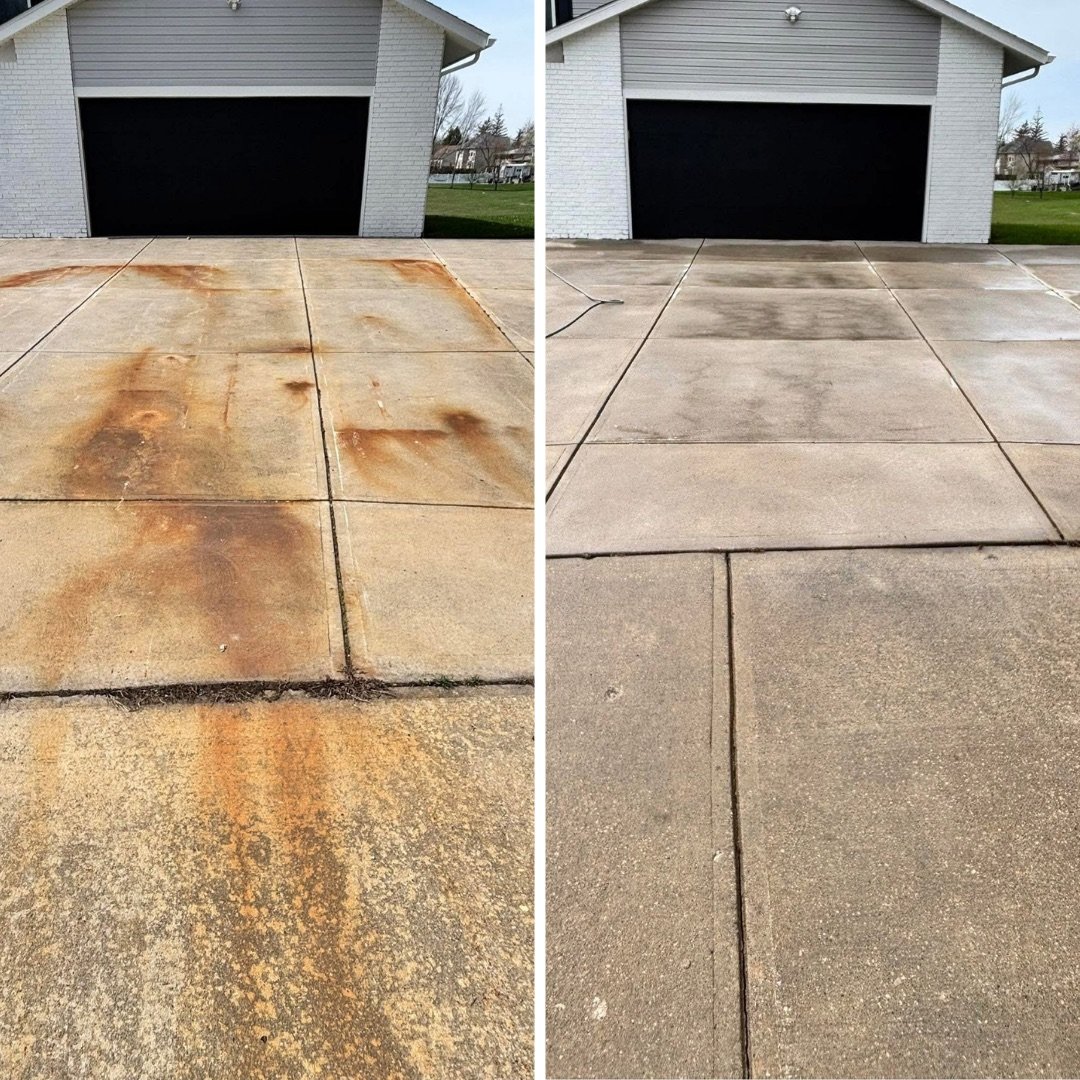 Concrete driveway before and after pressure washing, with heavy rust staining removed