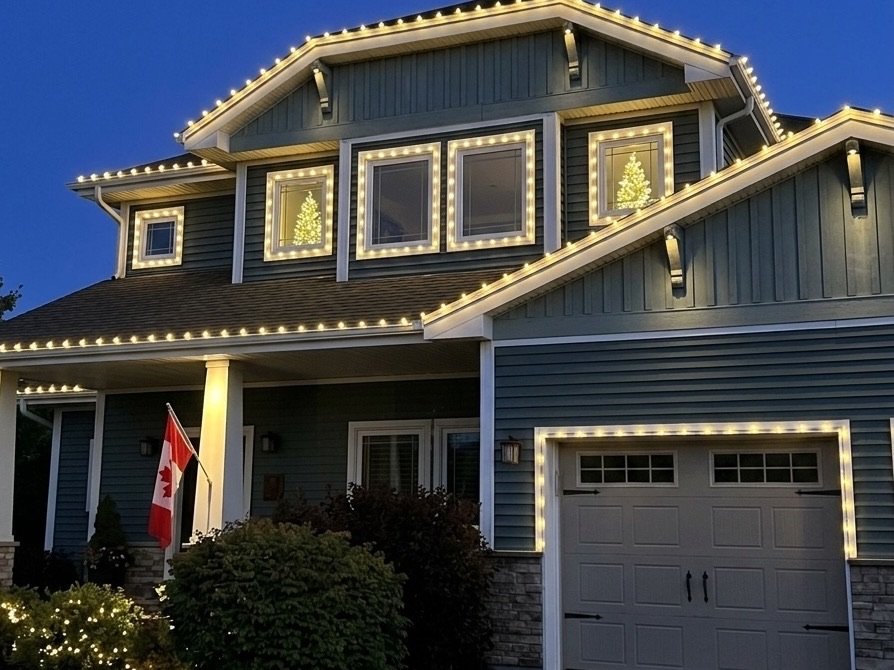 A Halifax home glowing with warm-white holiday lighting at dusk
